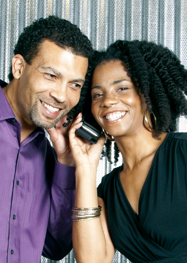 couple listening to one phone between them