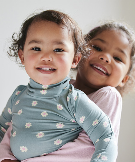 big sister holds little sister