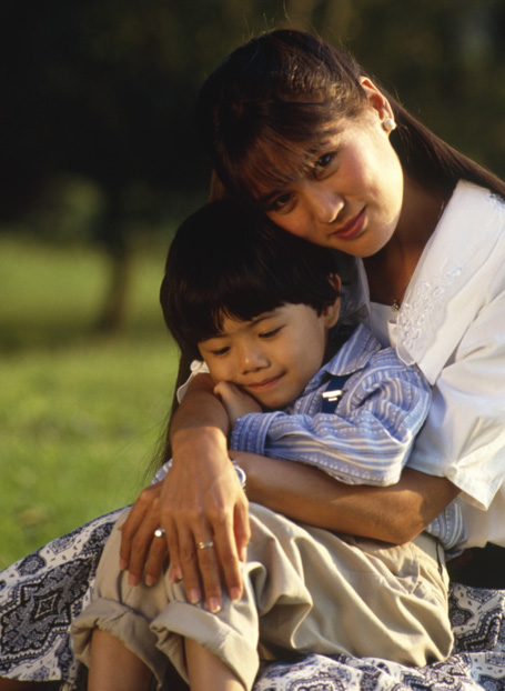 mom holding young boy in her lap