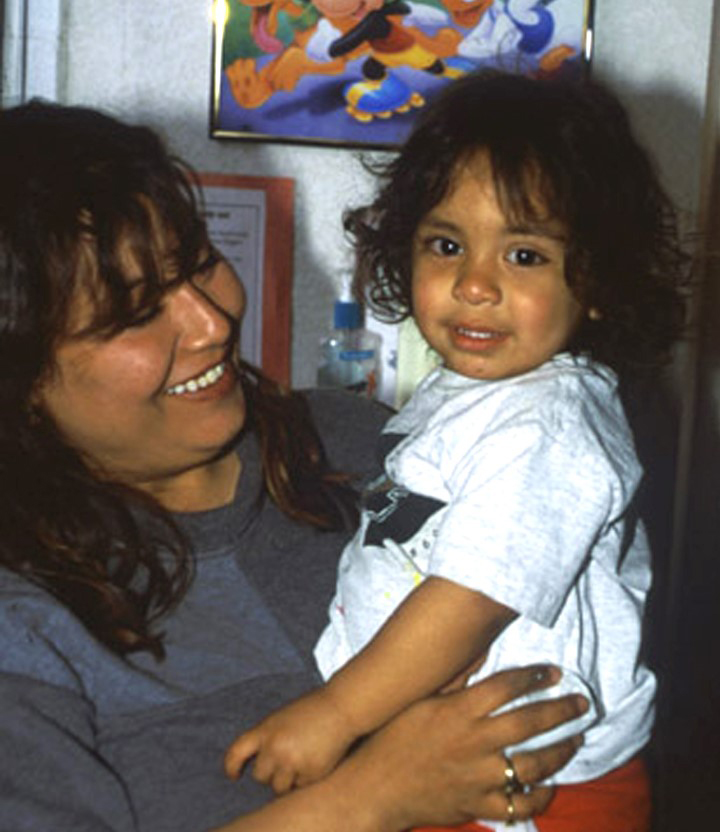 young child being held by mother