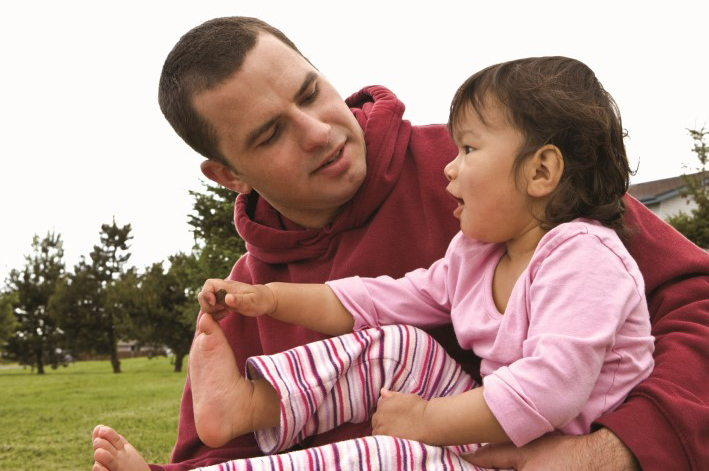 dad holding girl outside