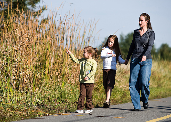 mom and family walking beside crops