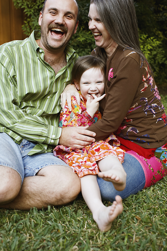 Family laughing in the yard