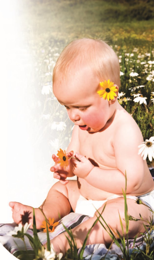 Baby sitting in a flower field