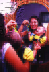 Baby watching their mom's toy keys in the mirror