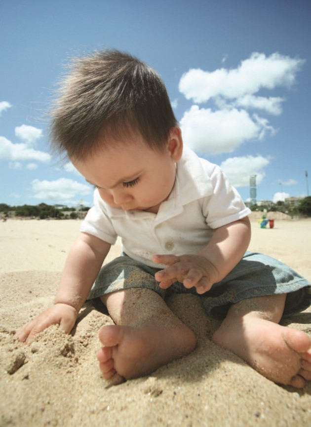Baby playing in the sand 