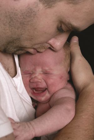 Dad holding his newborn baby