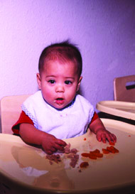 Baby eating in a high chair