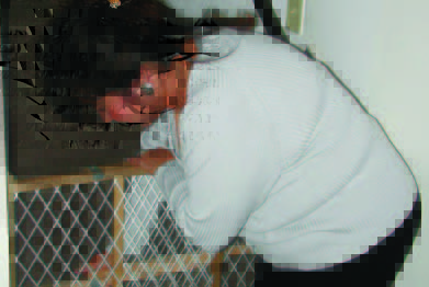 Mom installing a baby gate