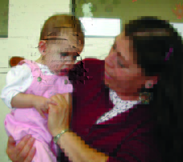 Grandma holding the baby and playing with her