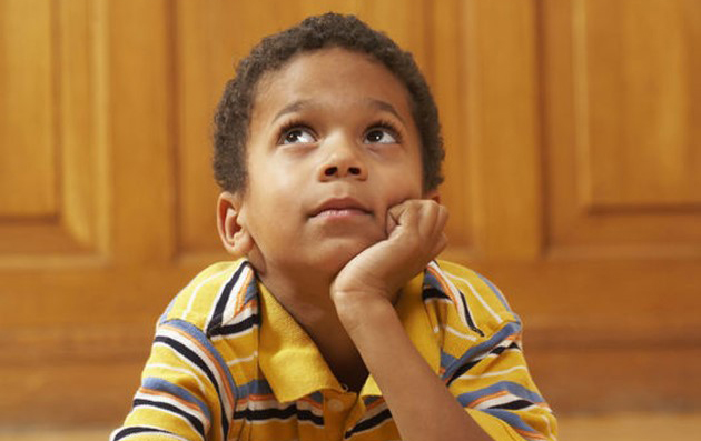 Young boy daydreaming