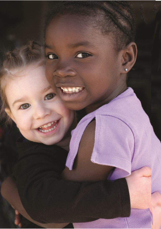 Two girls hugging and smiling