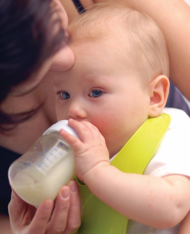 Mother feeding baby a bottle