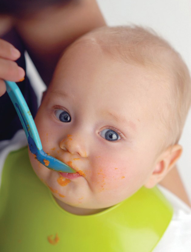Baby being spoon fed