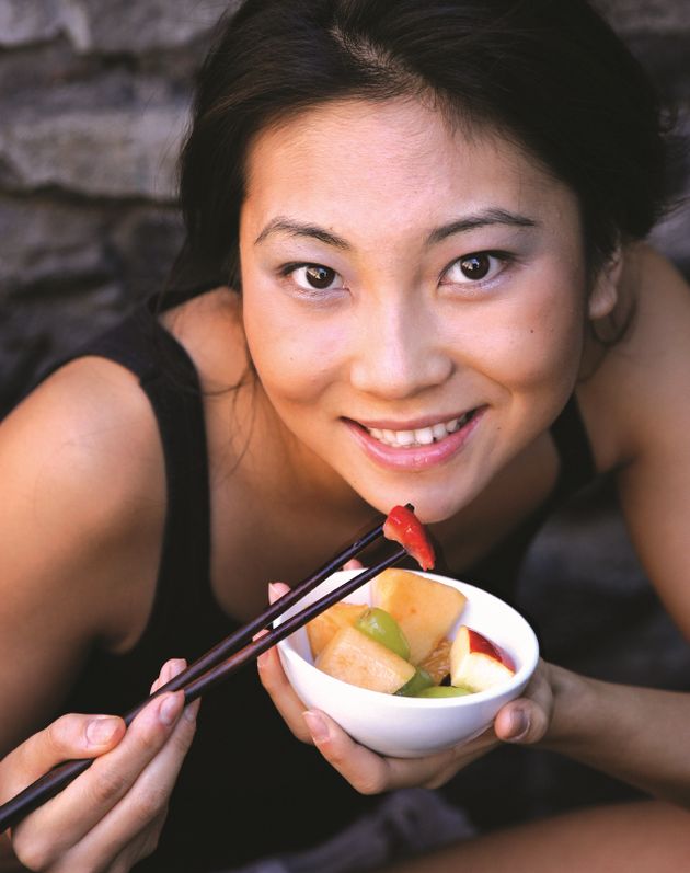 Mom eating fruit with chopsticks