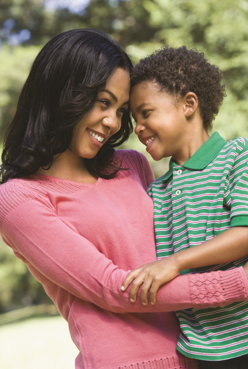 Mom and son hugging and smiling