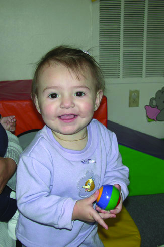 Baby smiling with her ball