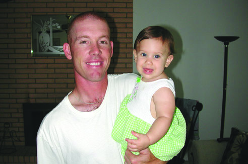 Dad holding his baby and smiling