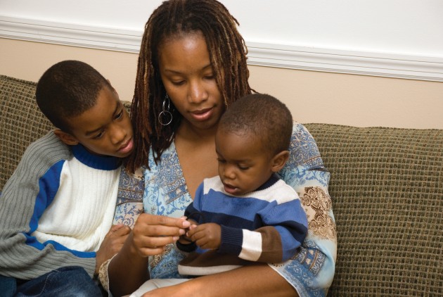 Mom with her two kids sitting on the couch