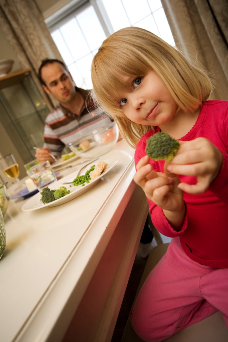 Young girl posing with her broccoli