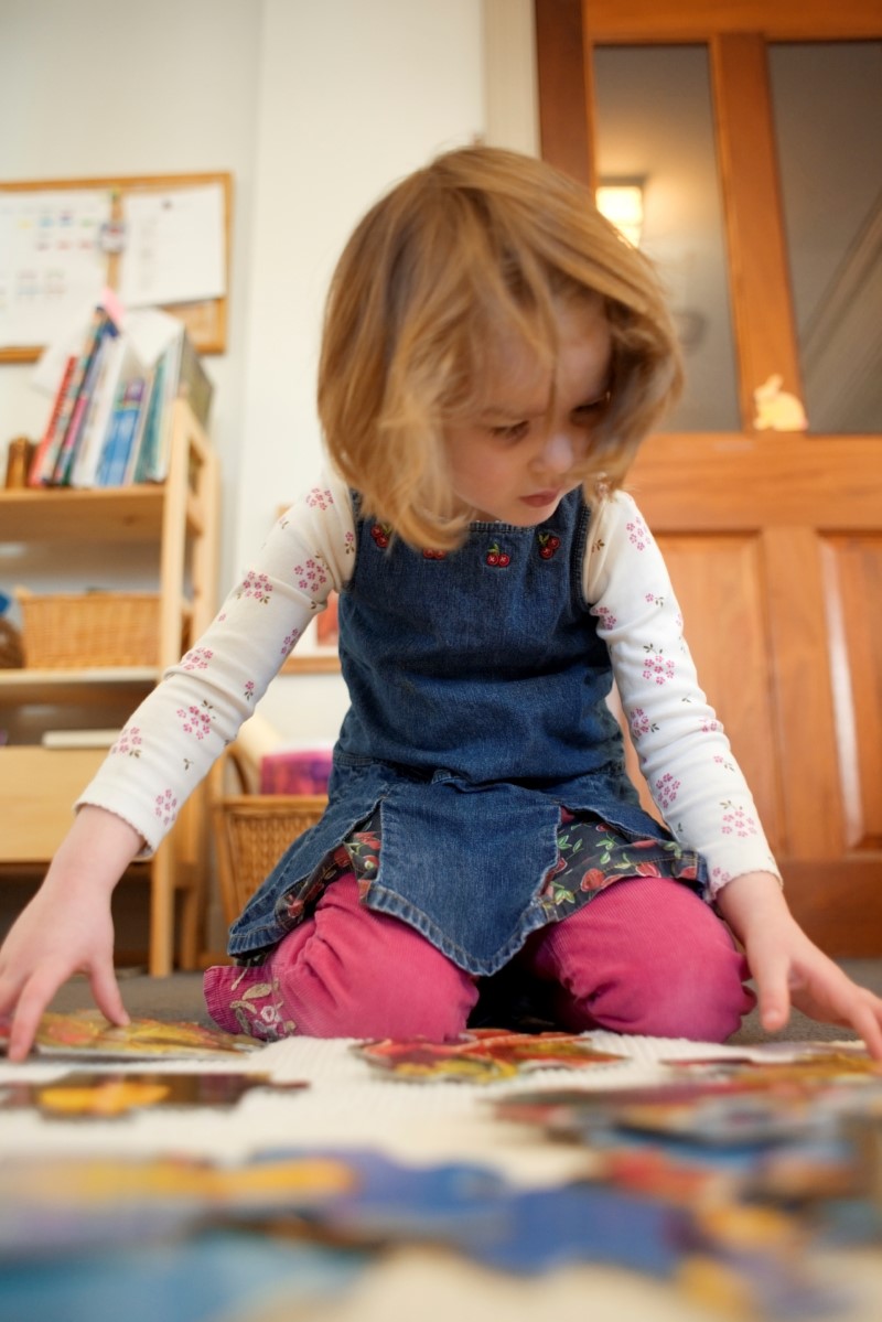 Young girl doing a puzzle