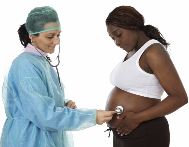 Doctor listening to mom's belly