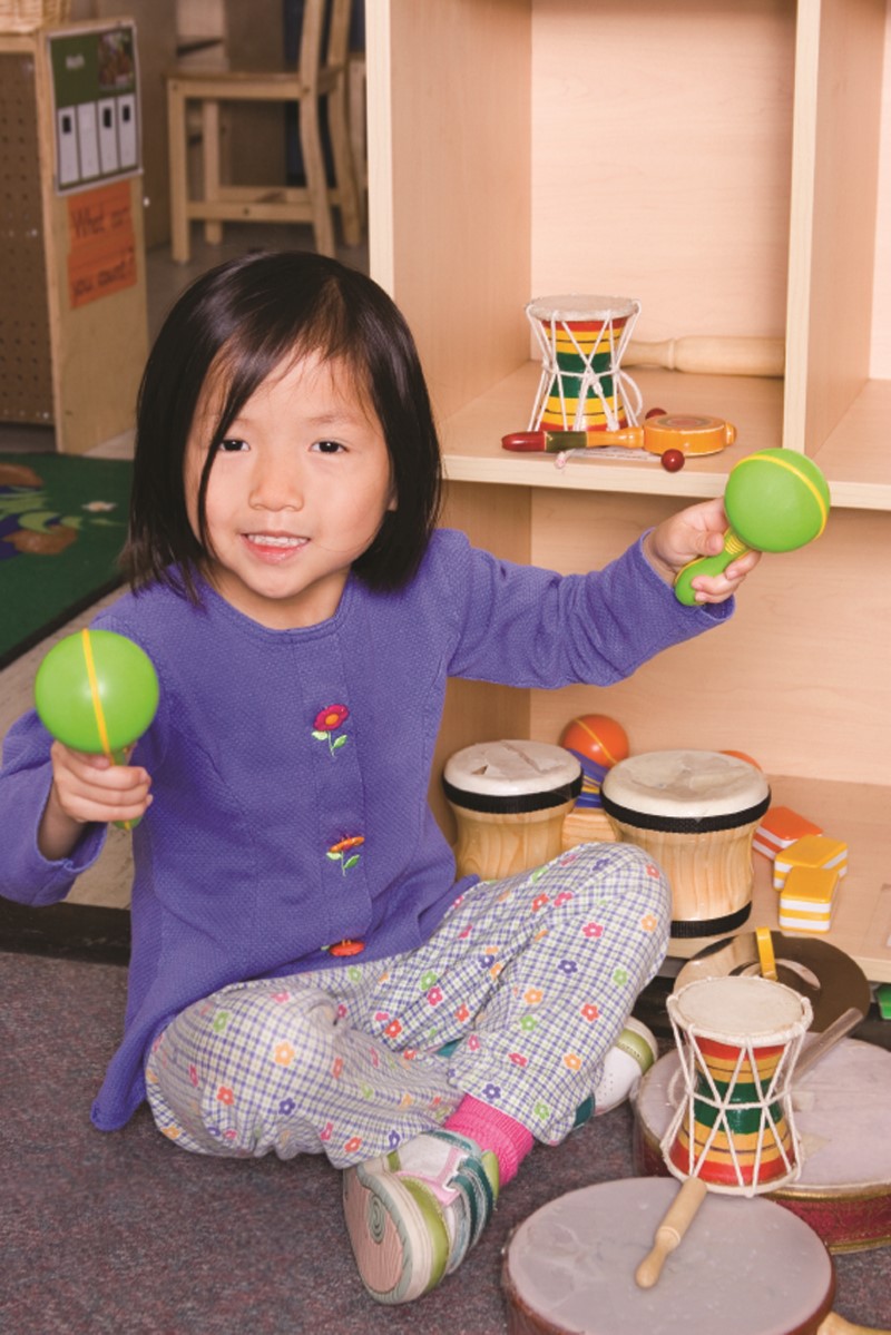 Girl sitting with musical toys
