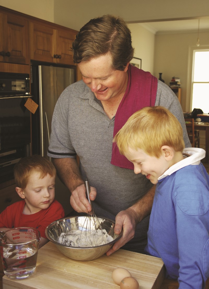 Dad cooking with his sons