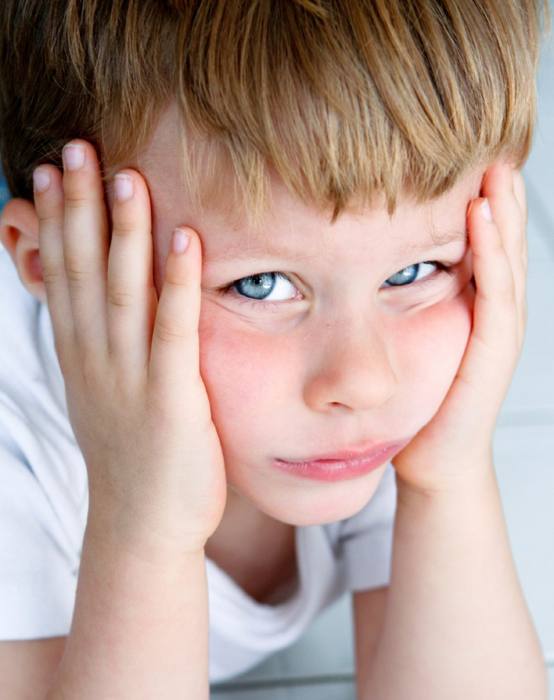 Sad boy with his head in his hands