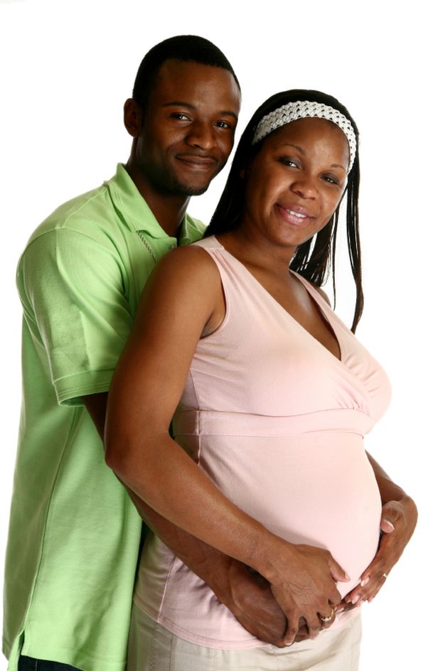 Dad supporting expecting mom's stomach