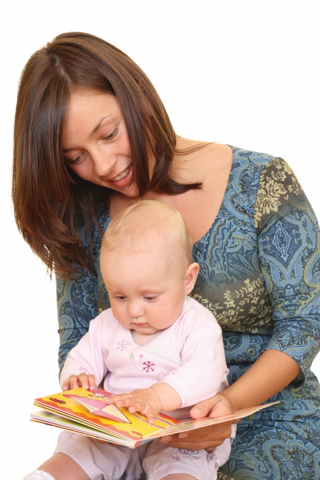 Mom reading with her baby in her lap