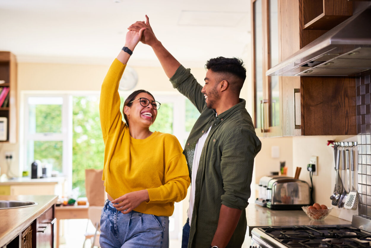 Couple dancing in the kitchen together