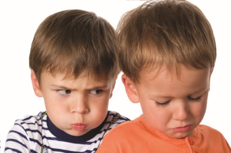 Las caras de dos niños pequeños mirando con expresión de enfado