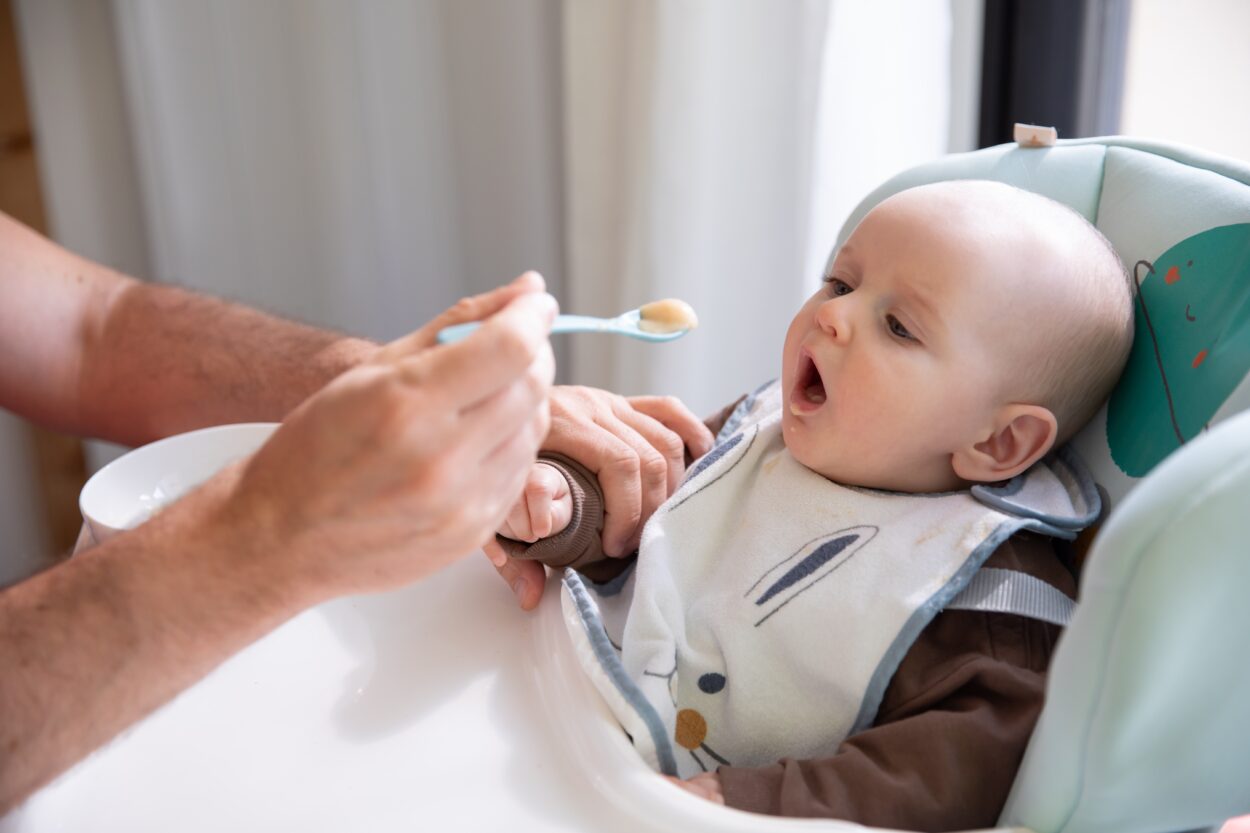 Feeding baby in a high chair